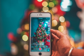 Frau fotografiert Weihnachtsbaum